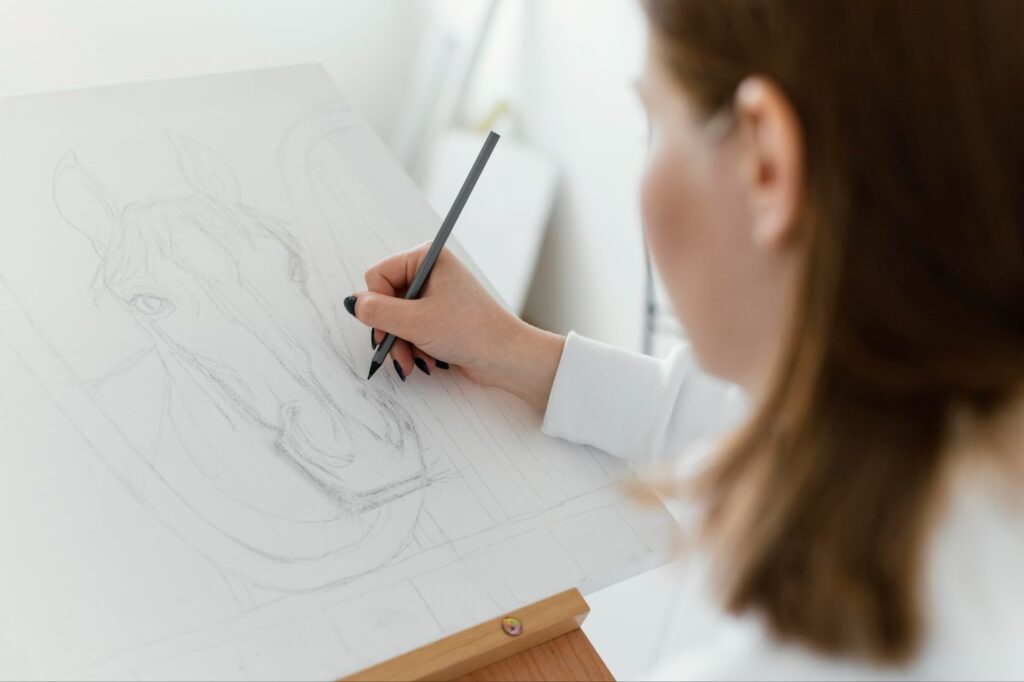 Woman drawing horse on canvas