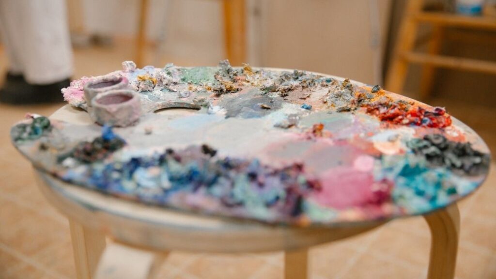 Palette with paints on a chair
